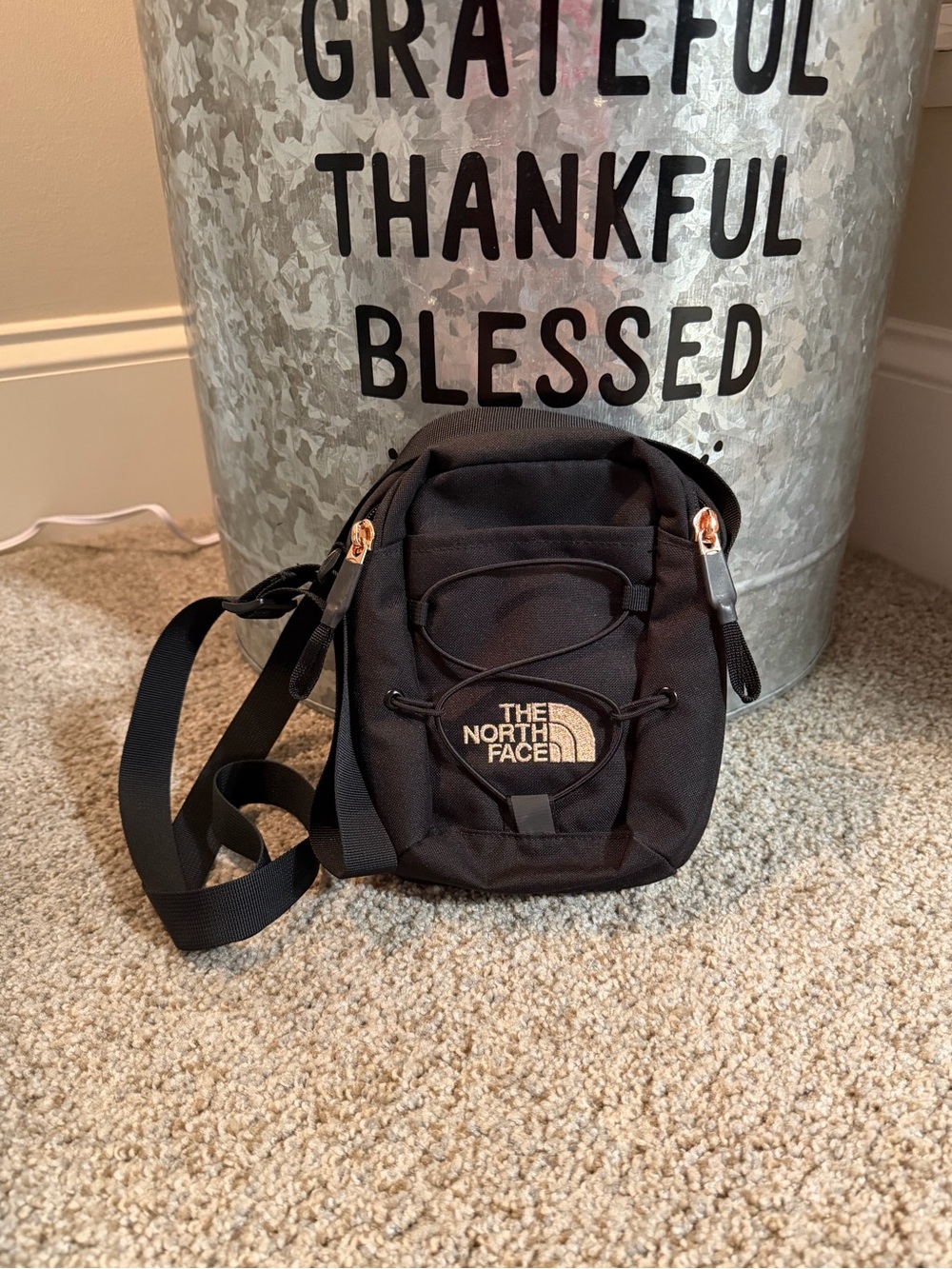 The North Face Jester Crossbody Mini Bag with Logo. Black/Burnt Coral Metallic.